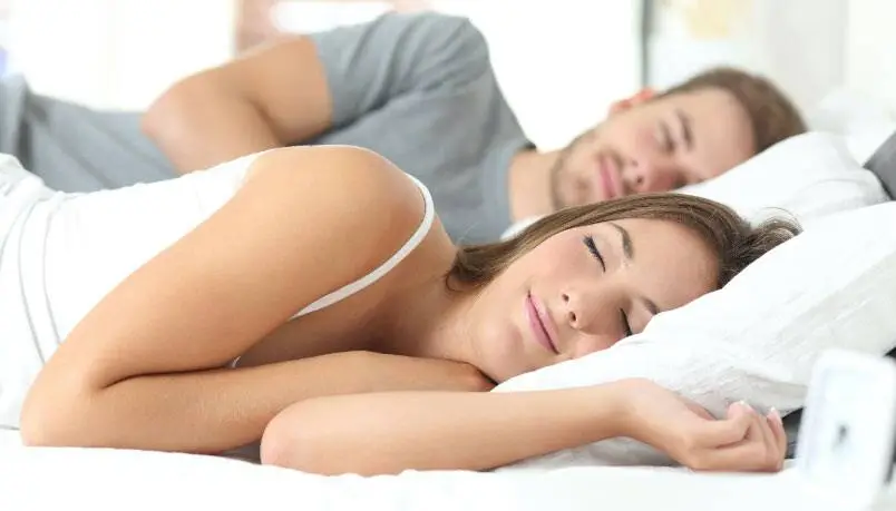 Couple Sleeping Together in Bed