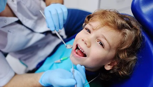 A young child receiving an orthodontic examination, showcasing orthodontic treatment services in Plymouth