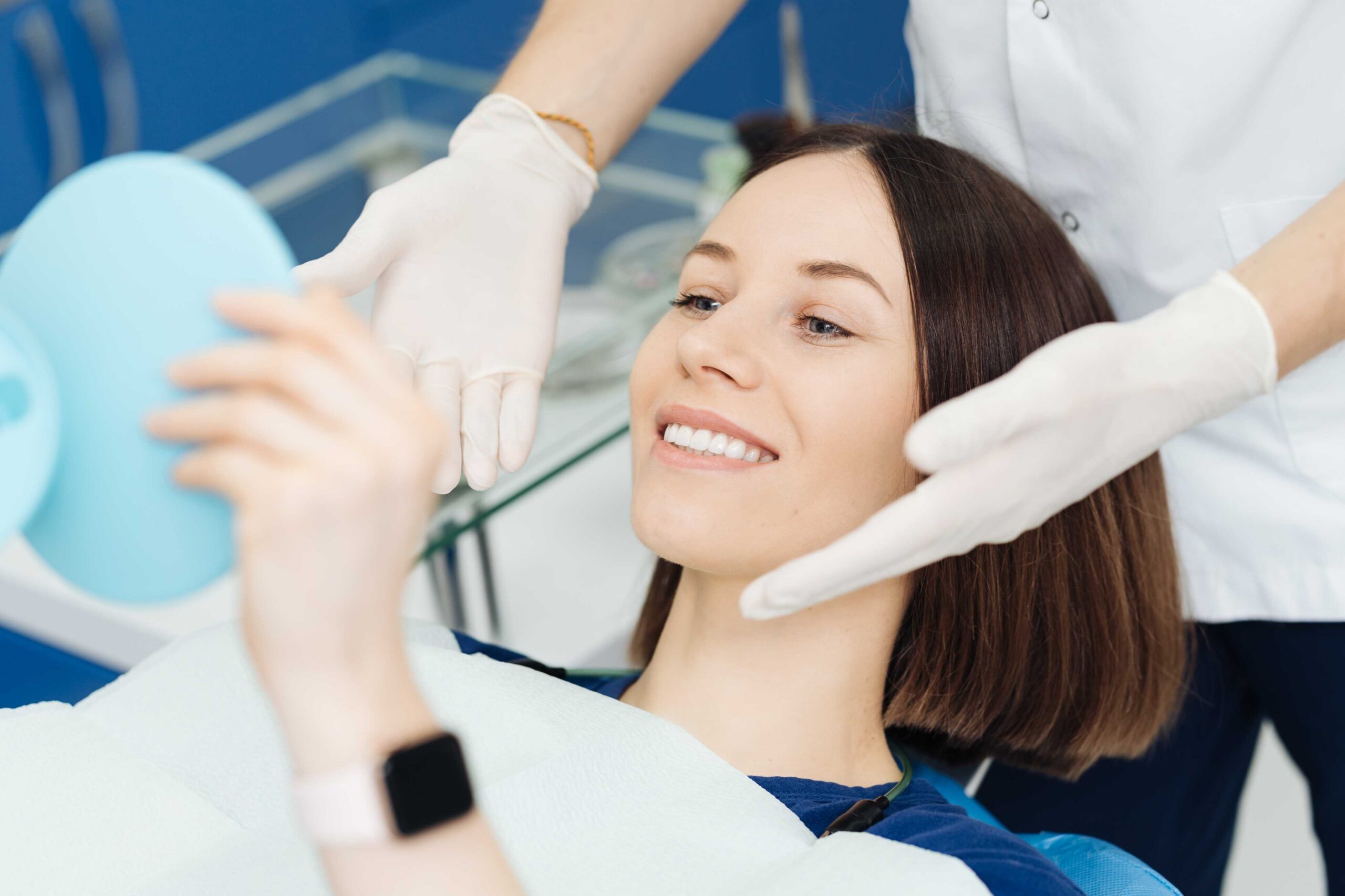 Patient checking smile in a dental mirror.