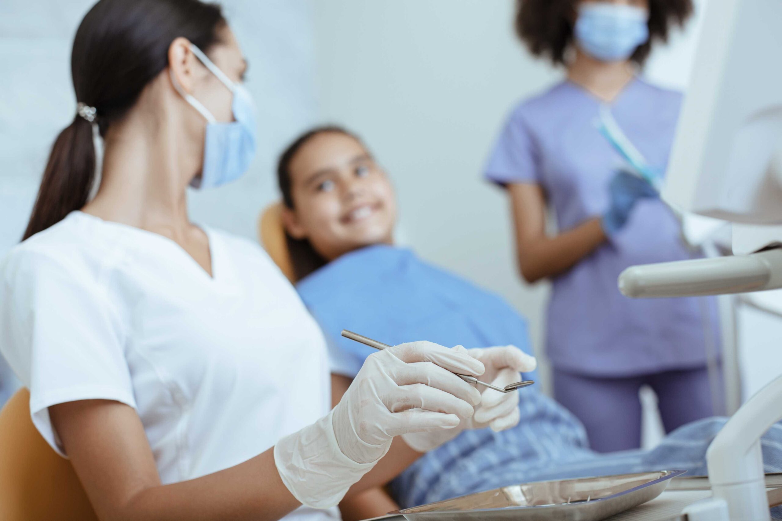 Child smiling during dental exam.