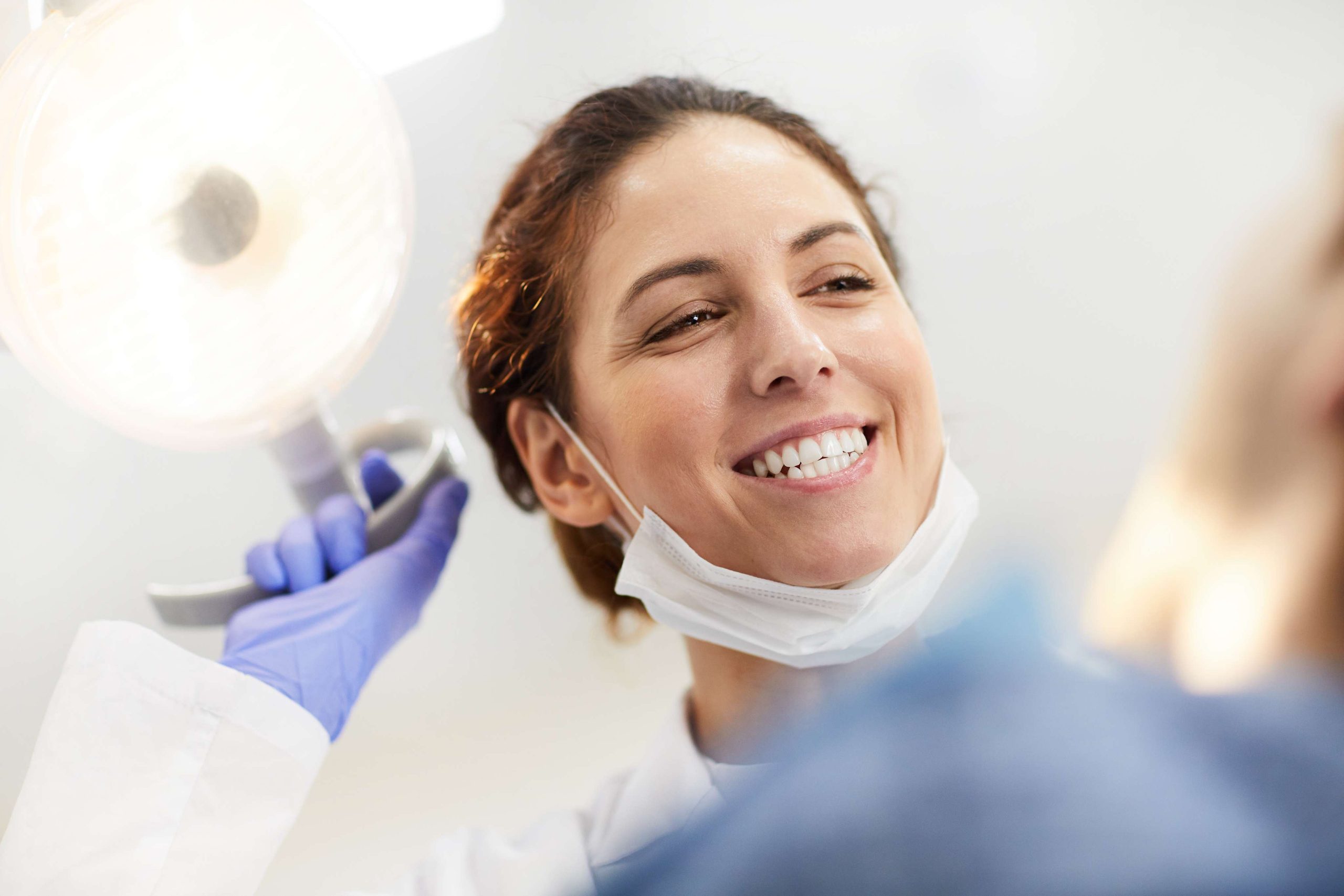 Smiling dentist with patient.